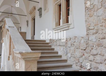 Strong staircase to the porch of an old stone building. Stock Photo