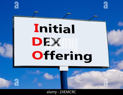 IDO initial DEX offering symbol. Concept words IDO initial DEX offering on beautiful big billboard. Beautiful blue sky cloud background. Business IDO Stock Photo