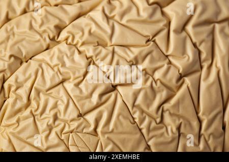 The image is a texture of a piece of paper or plastic with a brownish color. The paper appears to be torn and has a rough texture. The paper is in the Stock Photo
