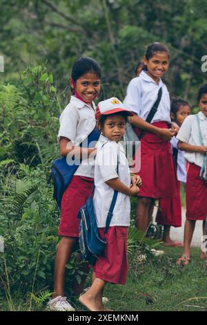 School children standing together on a road on a roadside in West Sumba Regency, Indonesia; West Sumba Regency, East Nusa Tenggara, Indonesia Stock Photo