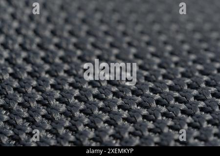 Close up detail of grey knitted fabric texture background. Macro Stock Photo
