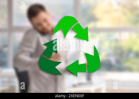 Recycling symbol and businessman in office Stock Photo