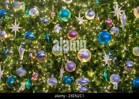 Christmas ornaments and lights on an artificial tree Stock Photo