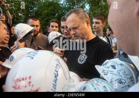 Moscow, Russia. 28th of June, 2024. Mikhail Gordin (C), Rector of Bauman Moscow State Technical University, signs helmets for university graduates in Moscow, Russia Stock Photo