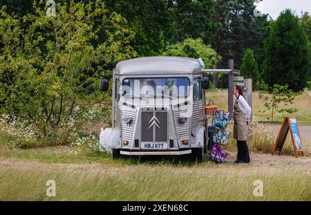 A vintage silver classic Citroen van converted for selling snacks and food at RHS Garden Wisley, Surrey, south-east England in summer Stock Photo