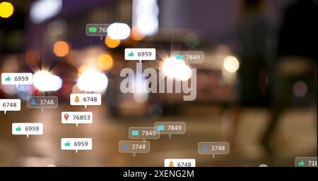 Image of social media icons and numbers over out of focus city lights Stock Photo