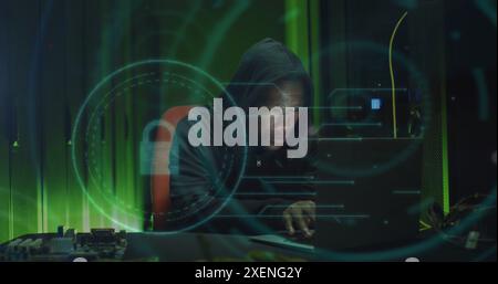 Image of padlock icon over african american male hacker using laptop Stock Photo