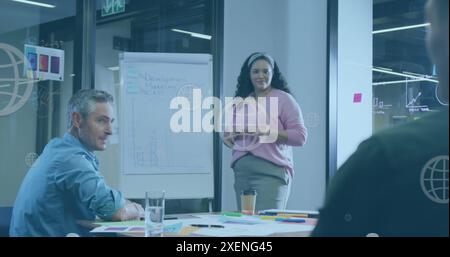 Image of web globe icons floating against biracial woman giving a presentation at office Stock Photo