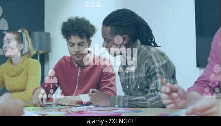 Image of network of profile icons floating against diverse men discussing at office Stock Photo
