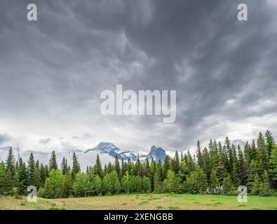 Overcast sky over Mount Lougheed and Wind Tower in the Canadian Rockies near Banff National Park, Alberta Stock Photo