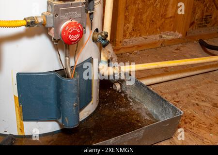 Water gushing out of water heater drain Stock Photo