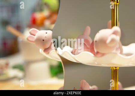 Small figurine in the shape of a rabbit, used as decoration, around the piece assembled for a baptism Stock Photo