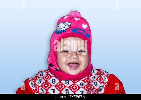 Joyful indian child wearing winter cap looking at camera Stock Photo