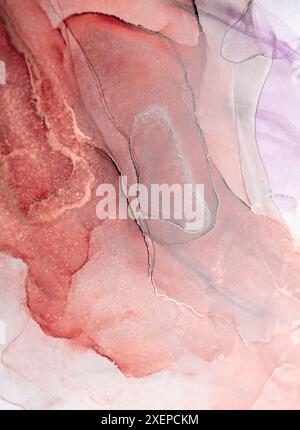 A close-up abstract image of swirling ink in shades of rose gold and grey. The intricate patterns create a unique and mesmerizing visual experience Stock Photo