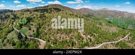 Drone shot of a travel road cutting through Montenegro's lush landscape Stock Photo