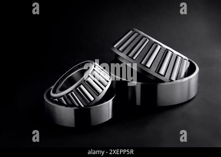 roller bearings on a black background, blank for creativity. Parts for machines and mechanisms in rotation units. Close-up selective focus copy space Stock Photo