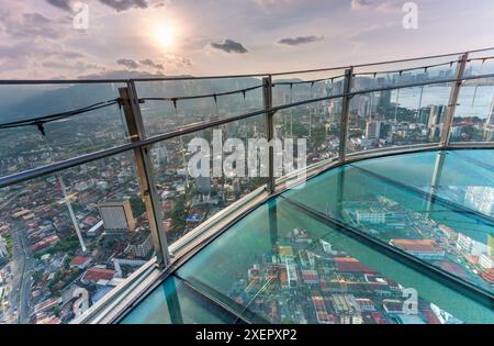 At sunset,atop George Town's tallest building,the transparent Skywalk,on floor level 68,is extended several feet outwards from the building,not recomm Stock Photo