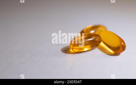 Very close-up of soft capsules of vitamins on white background. Stock Photo