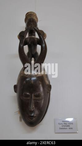 Beautifully-Carved, Wooden mask with human figure and horns, from National Museum, Lome, Togo.  Human figure standing on top of the head and horns. Stock Photo