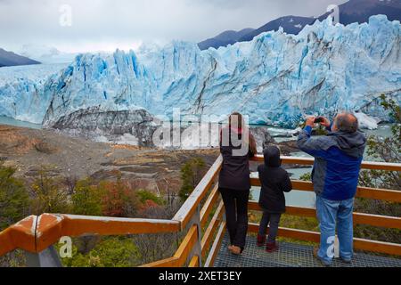 Tourist taking pictures. Mini trekking. Walk on the glacier with crampons. Perito Moreno glacier. Los Glaciares National Park. Near El Calafate. Santa Stock Photo