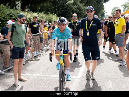 Mark Cavendish is seen on stage to present a trophy at the conclusion ...