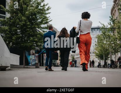Business professionals walking in the city on a cloudy day Stock Photo