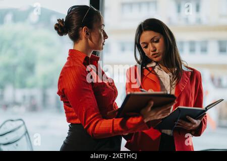 Young business entrepreneurs discussing during a meeting with notebooks Stock Photo