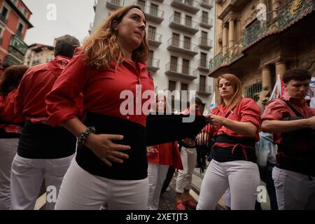 Pamplona, Spain. 29th June, 2024. Several members of the “Colla” prepare with the black sash typical of the Castellers' clothing, to begin the exhibition of the human towers. Members of the Colla Vella dels xiquets de Valls have held an exhibition of their human towers in Pamplona, ??Navarra, Spain. (Photo by Elsa A Bravo/SOPA Images/Sipa USA) Credit: Sipa USA/Alamy Live News Stock Photo