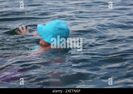 Odessa, Ukraine. 29th June, 2024. People relax by the water and swim on the beach 'At the Yellow Stone' Hot summer day near the Black Sea. People escape the heat through relaxing by the water. (Photo by Viacheslav Onyshchenko/SOPA Images/Sipa USA) Credit: Sipa USA/Alamy Live News Stock Photo