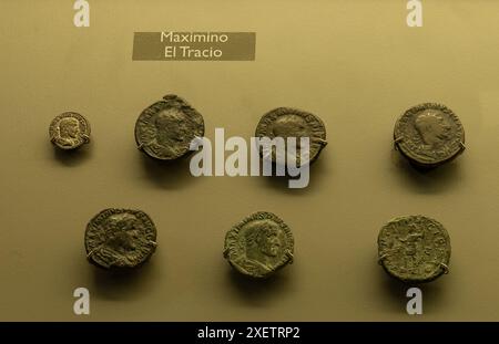 Display of ancient Roman coins from the reign of Maximinus Thrax. Various coin designs and inscriptions highlighting the era of the Thracian emperor. Stock Photo