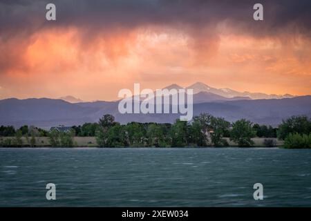 dramatic, stormy sunset with high wind over Longs Peak and Front Range of Rocky Mountains in northern Colorado Stock Photo