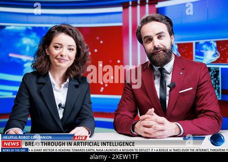 Newscasters team reveal AI progress on live television program, announcing breaking news about experts developing artificial intelligence. Media presenters commenting on high tech. Stock Photo