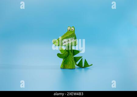 simple crocodile craft from paper and recycled egg box, DIY . Stock Photo