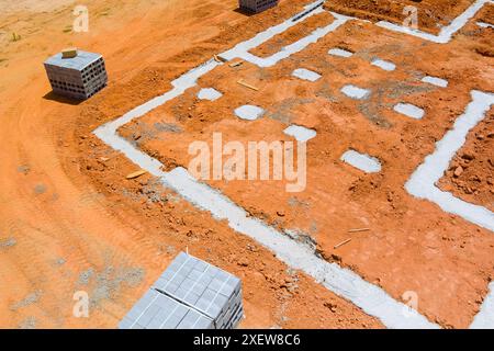 Cement blocks delivered to construction site with foundation is ready for mounting wall Stock Photo