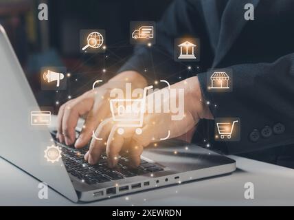 Businessman laptop using , online shopping concept. Shopper using a laptop computer with shopping cart and business icon, Online shopping and e-commer Stock Photo