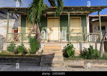 458 Vernacular wooden house of timber planks with porch on concrete platform and sheet metal roof, Cayo Granma Key fishing community. Santiago-Cuba. Stock Photo