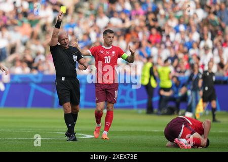 Berlin, Germany. 29th June, 2024. Referee Szymon Marciniak (L) shows a yellow card during the UEFA Euro 2024 round of 16 match between Switzerland and Italy in Berlin, Germany, June 29, 2024. Credit: Peng Ziyang/Xinhua/Alamy Live News Stock Photo