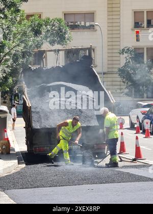 Workers paving the street. Barcelona, Catalonia, Spain. Stock Photo