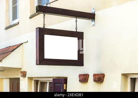Blank Mock Up Of Restaurant Wooden Vintage Street Signboard On Yellow Wall Stock Photo