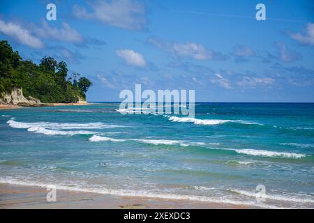 The image showcases the beautiful shoreline in the Andaman Islands against the blue sky and the Bay of Bengal showcasing the different colors. Stock Photo