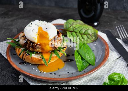 Delicious breakfast with poached eggs, bun and chicken cutlet. Eggs Benedict Stock Photo