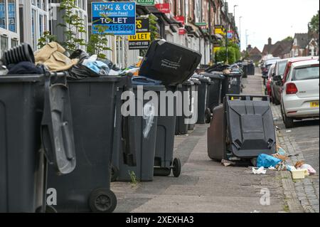 Selly Oak, Birmingham, June 30th 2024 - Many pavements were blocked by bins, forcing residents to walk into the road. - Residential streets in Birmingham have been turned into dumping grounds as students move house at the end of their contracts. Most of the students attend University of Birmingham which is around half a mile from the Selly Oak terraced housing streets. The roads have mainly been bought up by landlords who rent them out to the undergraduates with row upon row of 'For Rent' signs. Credit: Stop Press Media/Alamy Live News Stock Photo