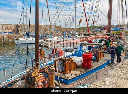 Portsoy Boat Festival boats in the harbour the deck of the Swan from Lerwick Stock Photo