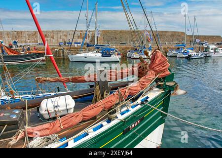 Portsoy Boat Festival boats in the harbour the green prow of the Swan from Lerwick Stock Photo