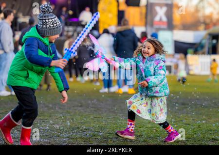 Canberra, Australia. 30th June, 2024. Children are pictured during the July Christmas event in Canberra, Australia, June 30, 2024. Canberra's July Christmas event took place here from June 27 to 30. As a unique celebration in the Southern Hemisphere, July Christmas stems from Australians' longing for a traditional white Christmas. Since December is summer in Australia, people celebrate a 'fake' Christmas in July to experience a snowy festive atmosphere. Credit: Xinhua/Alamy Live News Stock Photo