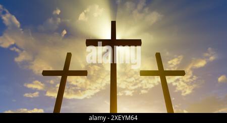 Three Jesus Christ christian crucifixes or crosses backlit from sunset ...