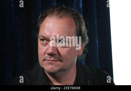 Munich, Germany. 30th June, 2024. Charly Hübner, actor, stands before the premiere of the series 'Turmschatten' in the Astor Filmlounge at the ARRI Cinema. Credit: Karl-Josef Hildenbrand/dpa/Alamy Live News Stock Photo