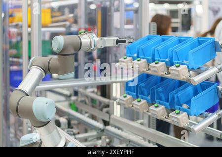 robotic arm integrated into an automated assembly line, illustrating the advanced technology and precision used in modern manufacturing processes. Stock Photo
