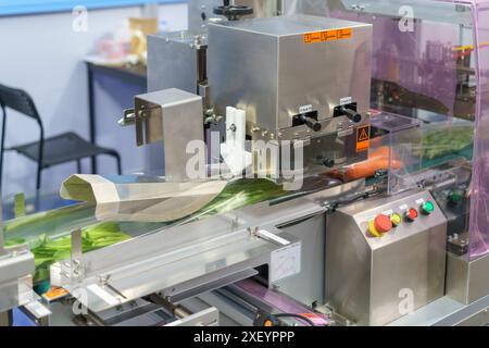 automated vegetable packaging machine, specifically designed to handle fresh produce efficiently and hygienically. Stock Photo