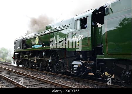 Sir Archibald Sinclair a rebuilt Battle of Britain class locomotive pulling a passenger train out of Sheffield Park station. Stock Photo